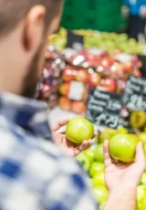 Man looking at apples